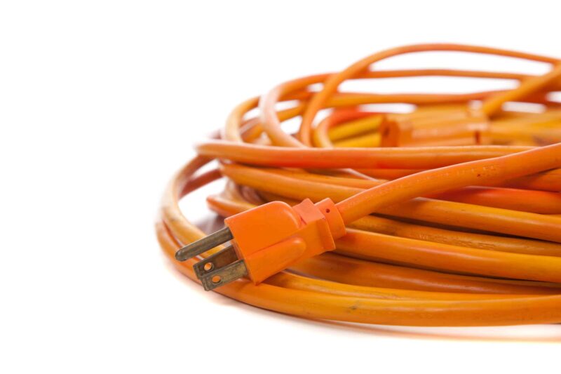 An Orange Extension Cord On White