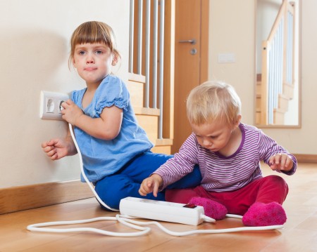 24830917 Children Playing With Electrical Extension And Outlet At Home