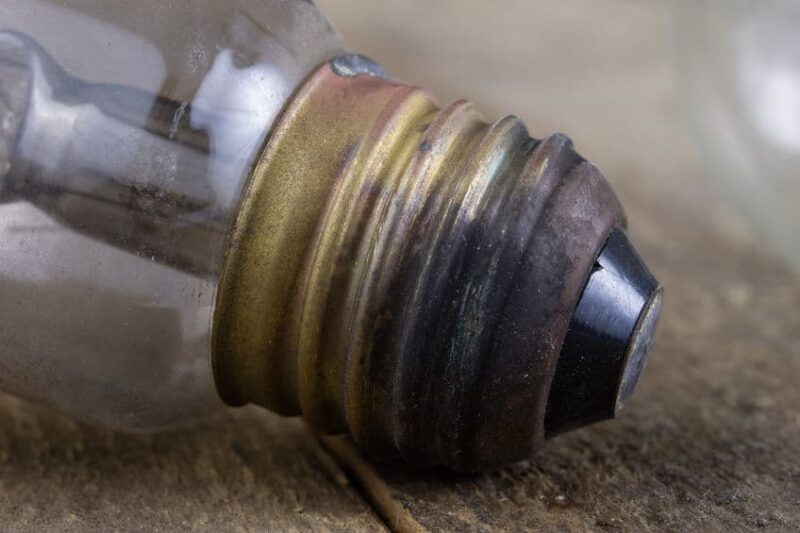 Light Bulb Lying On A Wooden Table. Lighting Accessories In The