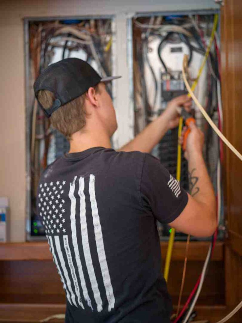 Licensed EV installer inspecting a residential EV charger in Indianapolis