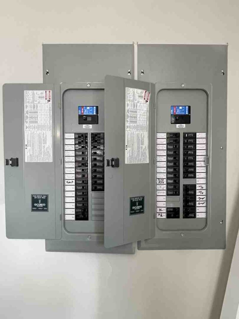 homeowner inspecting modern breaker panel